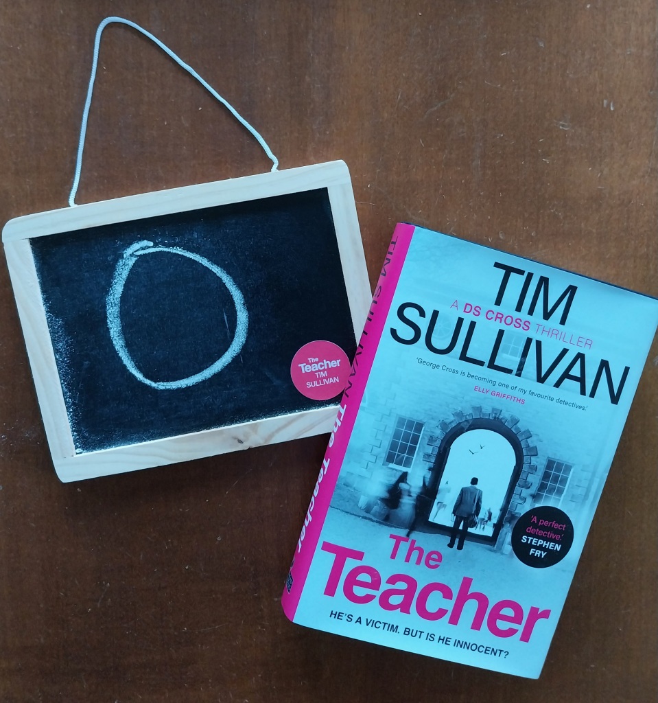 Book cover The Teacher by Tim Sullivan Blackboard with chalk letter O